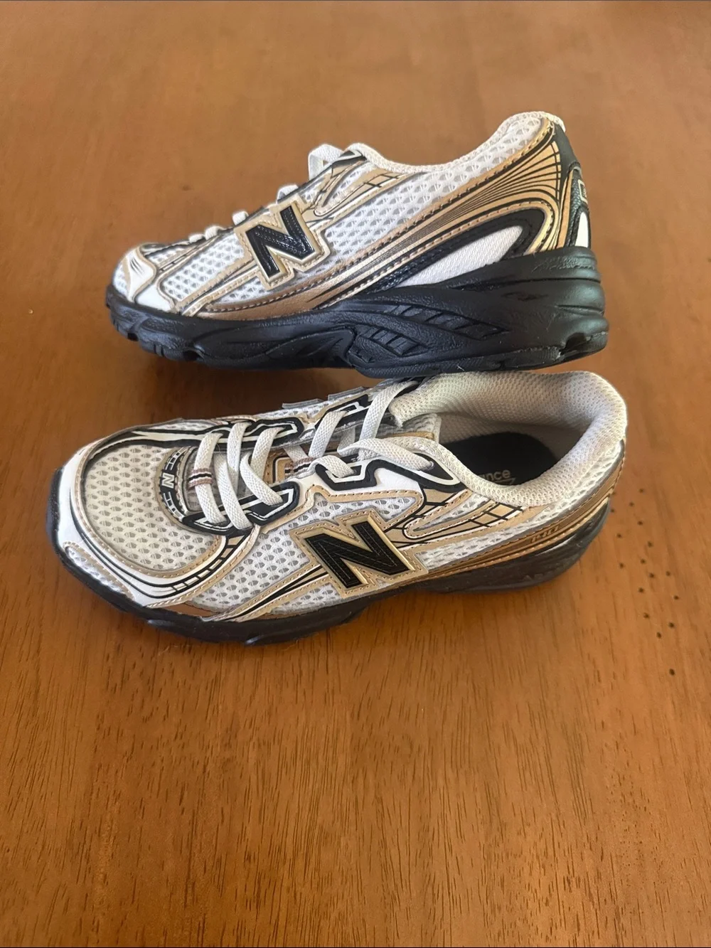 New Balance Kids White and Gold Athletic Sneakers with Black Soles
